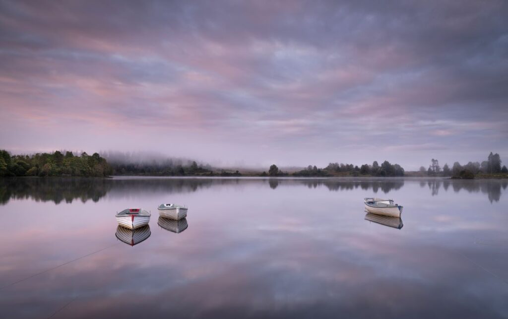 Travelling Without Moving’, an atmospheric shot of boats on Loch Rusky in the Trossachs.