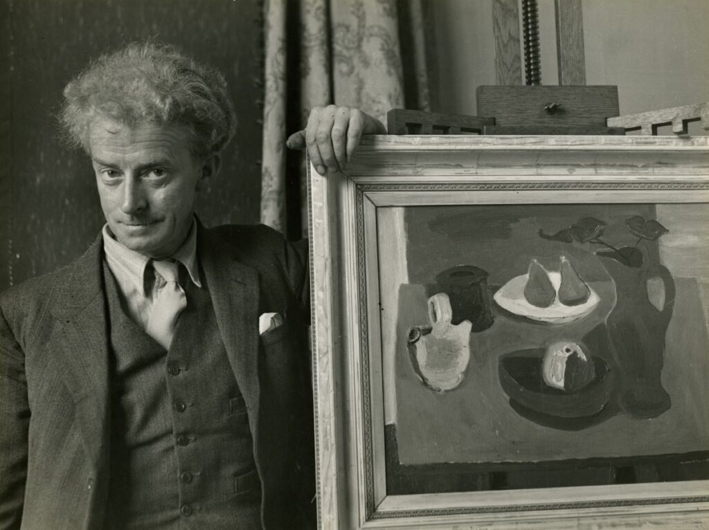 Sir William Gillies with a still life painting by Lida Moser. Credit The Royal Scottish Academy.