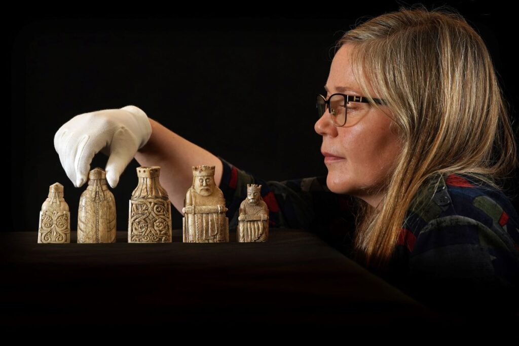 Dr Alice Blackwell with some of the Lewis chess pieces. Credit: Stewart Attwood 