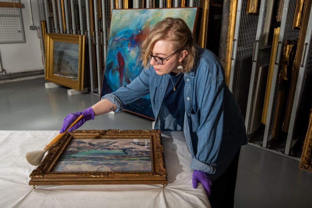 Exhibition Curator, Kirsty Matheson preparing an artwork for A Weather Eye Credit: Alan Richardson