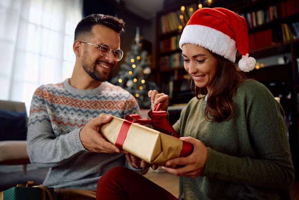 Happy woman opens gift box from her boyfriend on Christmas day at home.
By Drazen