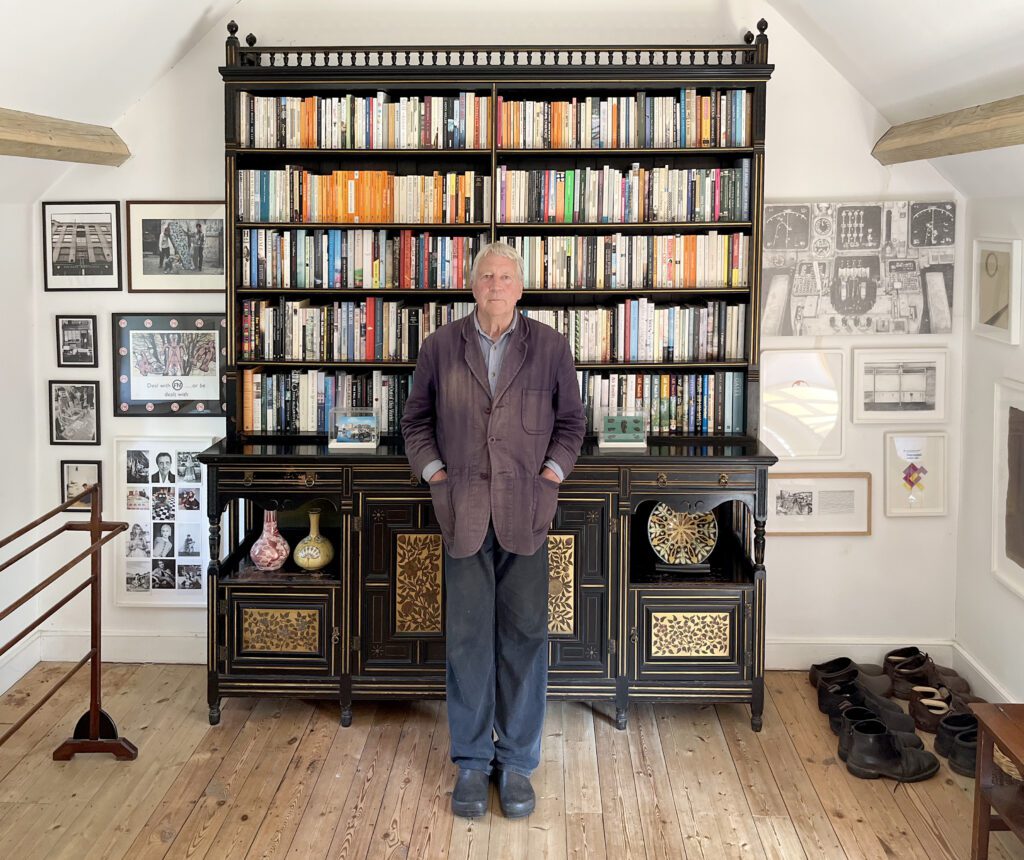 Jeremy Cooper in front of a bookcase in the bedroom of his cottage in Somerset. Credit: Jeremy Cooper 