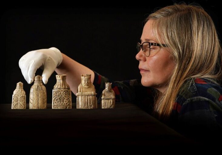 Dr Alice Blackwell with some of the Lewis chess pieces. Credit: Stewart Attwood 