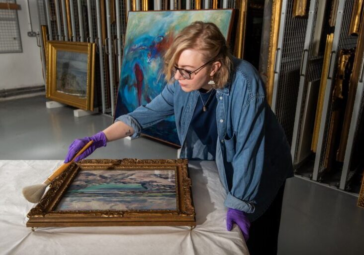 Exhibition Curator, Kirsty Matheson preparing an artwork for A Weather Eye Credit: Alan Richardson