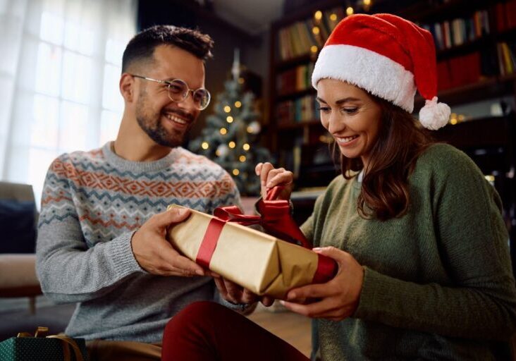 Happy woman opens gift box from her boyfriend on Christmas day at home.
By Drazen