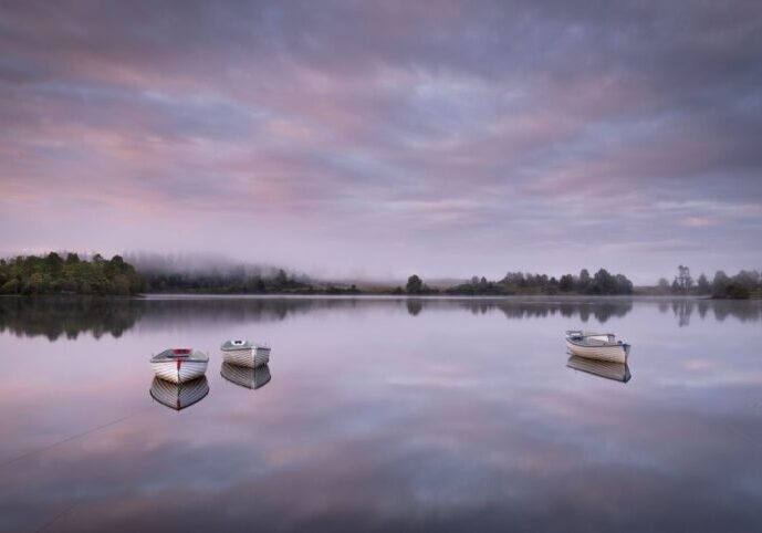 Travelling Without Moving’, an atmospheric shot of boats on Loch Rusky in the Trossachs.