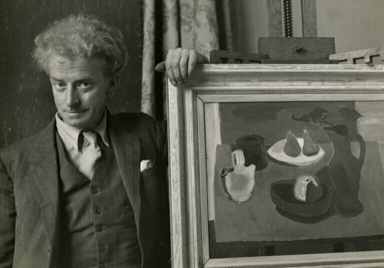 Sir William Gillies with a still life painting by Lida Moser. Credit The Royal Scottish Academy.